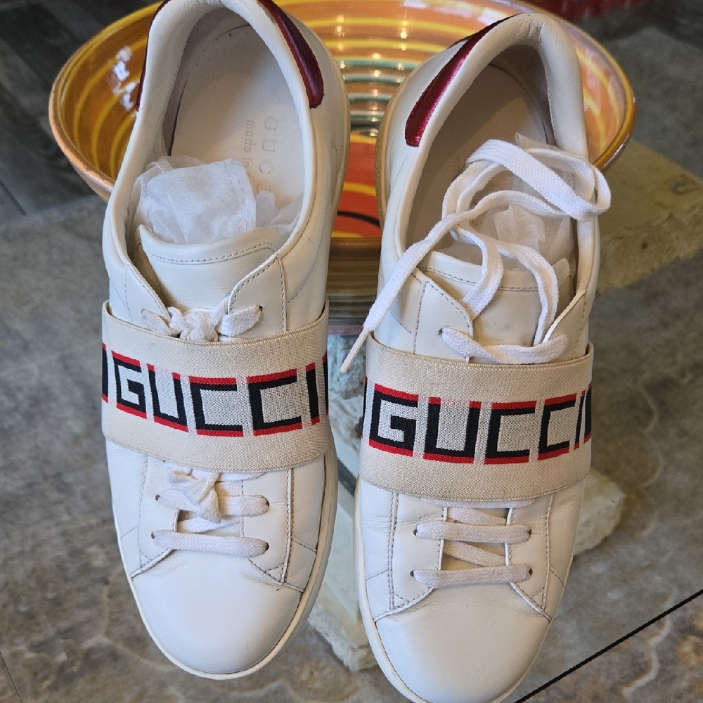 Gucci Leather Cream Sneakers with Red and Black Logo Strap.